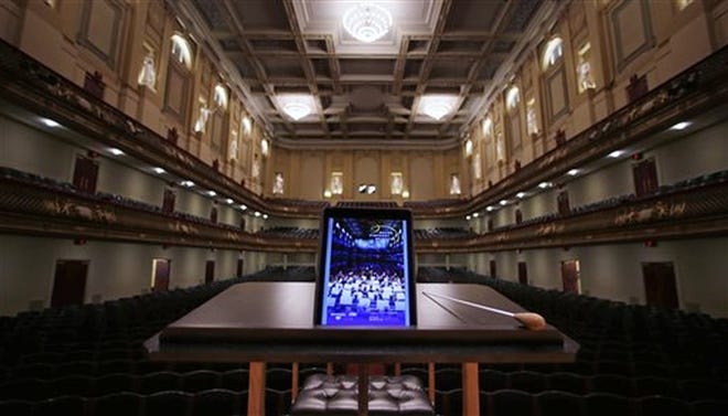An iPad with a Boston Symphony Orchestra interactive program is displayed on the conductor's stand at Symphony Hall recently. CHARLES KRUPA/The Associated Press