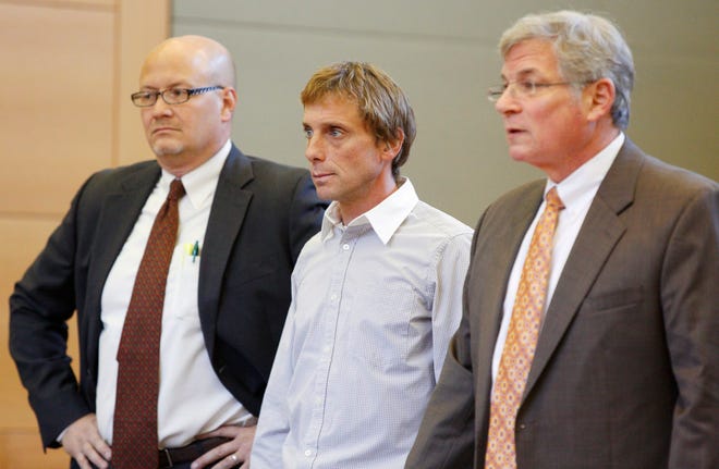 David Carlson, center, appears in Orange County Court in Goshen for arraignment in 2013 on charges involving the shooting death of Norris Acosta-Sanchez in Sparrowbush. He is standing between his lawyers David Wallace, left, and Benjamin Ostrer. TIMES HERALD-RECORD FILE PHOTO