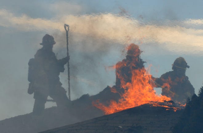 San Bernardino County Fire Department firefighters from several local stations battled a fire that spread through an abandoned building in the former George Air Force base housing area near SCLA on Monday afternoon. High winds hampered efforts. (James Quigg, Daily Press)