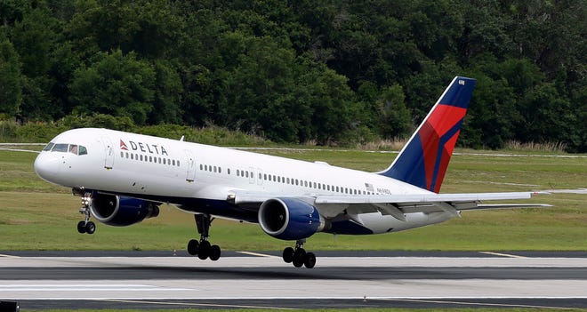 FILE - In this May 15, 2014, file photo, a Delta Air Lines Boeing 757-232 lands at Tampa International Airport in Tampa, Fla. Delta reports quarterly financial results on Tuesday, Jan. 19, 2016. (AP Photo/Chris O'Meara, File)