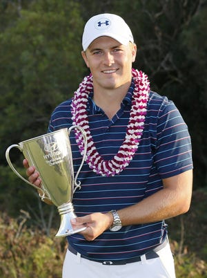 Jordan Spieth had a smile and a trophy after winning the Tournament of Champions in Hawaii with a score of 30 under par. Matt York/Associated Press