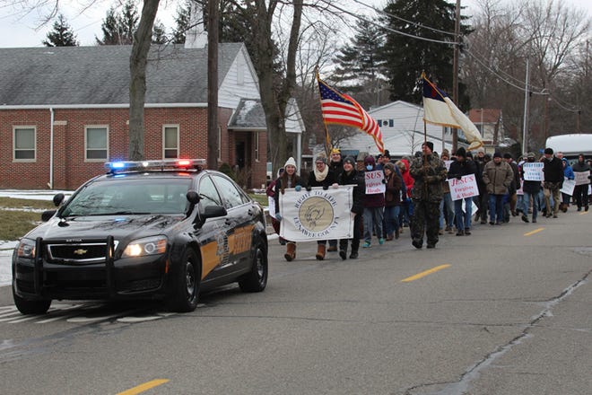 The Right to Life rally makes its way toward the old Lenawee County Courthouse.