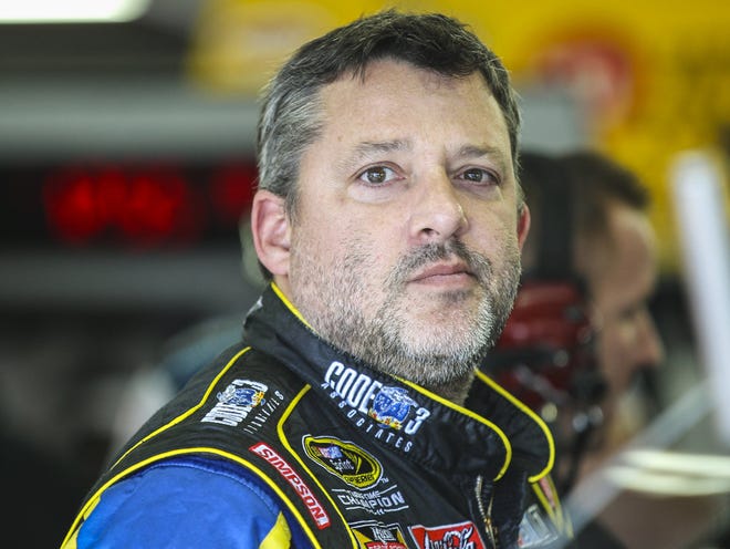 Driver Tony Stewart waits in the garage while his car is worked on during practice for the Sunday's NASCAR Sprint Cup series auto race at New Hampshire Motor Speedway in Loudon, N.H., Friday, Sept. 25, 2015.