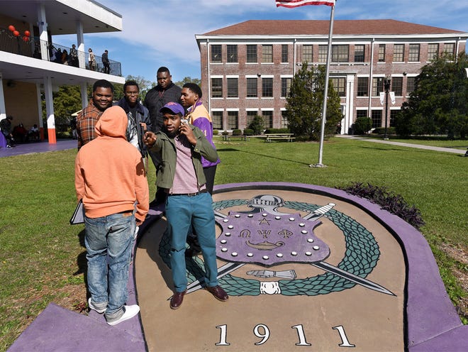 Members of the Omega Psi Phi fraternity hang out on their monument on the Centennial Lawn with the historic Centennial Hall in the background. The Centennial Hall the oldest building on the EWC campus, built in 1916 to celebrate the 100th. anniversary of the AME Church. Edward Waters College, the historic black college on Kings Road is celebrating its 150th. anniversary.