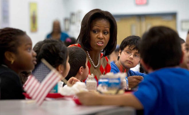FILE - In this Jan. 25, 2012 file photo, First lady Michelle Obama has lunch with school children at Parklawn elementary school in Alexandria, Va.  A bipartisan Senate bill released Monday would revise healthier meal standards put into place over the last few years to give schools more flexibility in what they serve the nation's schoolchildren, easing requirements on whole grains and delaying an upcoming deadline to cut sodium levels on the lunch line.  (AP Photo/Pablo Martinez Monsivais)