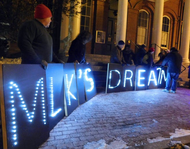 On Monday, Black Lives Matter supporters held lit letters spelling out ìMLKíS Dream?î Photo by Erik Hawkins/seacoastonline
