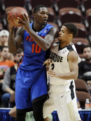 Florida's Dorian Finney-Smith is guarded by Purdue's P.J. Thompson, right, during the first half of an NCAA college basketball game in the Hall of Fame Tip-Off tournament, Sunday, Nov. 22, 2015, in Uncasville, Conn. (AP Photo/Jessica Hill)