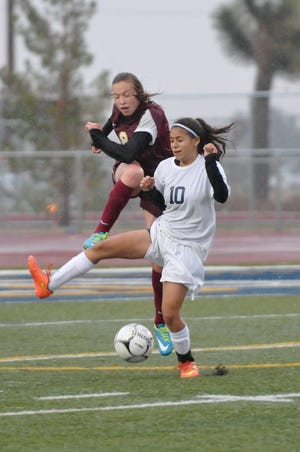 A pair of players battle for possession in Victorville on Tuesday. (David Pardo, Daily Press)