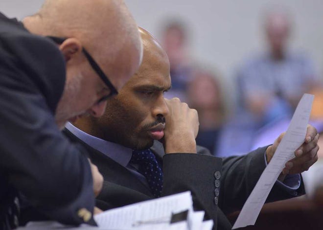 Accused cop killer Jamie Hood, right, speaks with his legal aid, Newell Hamilton, during the first day of jury selection in Hood's trial at the Elbert County Courthouse on Monday, June 1, 2015. Hood is charged in the fatal March 2011 shooting of Athens-Clarke County Senior Police Officer Elmer "Buddy" Christian.  (Richard Hamm/Athens Banner-Herald)