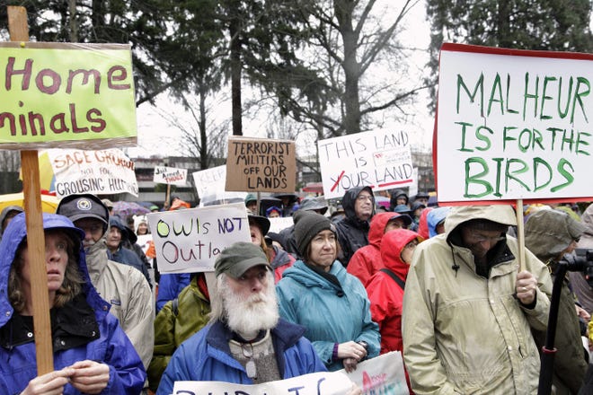 Portland, Ore., residents protest the occupation of a national refuge, Tuesday, Jan. 19, 2016 in southeastern Oregon. The protesters chanted "Birds not Bullies" and said the government should arrest occupiers. (AP Photo/Gosia Wozniacka)