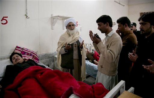 Pakistan villagers pray for the recovery of people injured in an attack on a university, at a local hospital in Charsadda town, some 35 kilometers (21 miles) outside the city of Peshawar, Pakistan, Wednesday, Jan. 20, 2016. Gunmen stormed Bacha Khan University named after the founder of an anti-Taliban political party in the country's northwest Wednesday, killing many people, officials said.