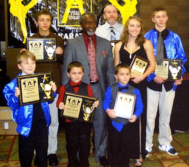 Members of the Donald McCluney School of Tae Kwon Do who received honors recently at a Charlotte banquet included, front row from left, Jesse Roper, Bobby Boles IV, Jordan Boles; second row, Erik Laughlin, Master Donald McCluney, Linsey Wagner, Jesse Hatcher; third row, Christopher Couch.
