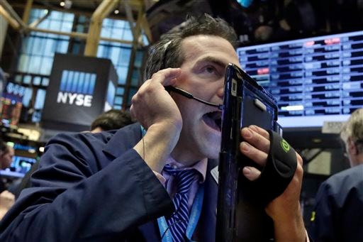 Trader Gregory Rowe works on the floor of the New York Stock Exchange, Wednesday. Energy stocks are leading another sell-off on Wall Street as the price of oil continues to plunge.