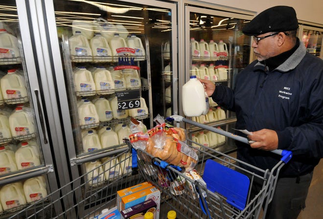 Jose Hernandez, of Philadelphia, stocks up on milk and other essentials at Aldi in Edgewater Park on Thursday, Jan. 21, 2016, as he prepares for the snowstorm. The National Weather Service on Thursday forecast "blizzard-like" conditions with snow starting later Friday.