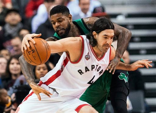 Toronto Raptors forward Luis Scola (4) tries to drive past Boston Celtics forward Amir Johnson during the first half of an NBA basketball game in Toronto on Wednesday, Jan. 20, 2016. (Nathan Denette/The Canadian Press via AP)