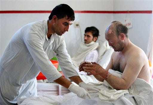 An injured victim from yesterday's suicide attack near the Russian Embassy, receives treatment at a hospital in Kabul, Afghanistan, Thursday, Jan. 21, 2016. A deadly Taliban attack on a bus carrying employees of Afghanistan"™s biggest TV station drew widespread condemnation on Thursday as an attack on freedom of speech and the country"™s young and fragile media sector. A suicide bomber struck the minibus with workers from Tolo TV, owned by the private Moby Group, the country"™s biggest media organization. many people were killed and more than twenty were wounded in the explosion. The bus was hit as it was passing near the Russian Embassy, which triggered initial speculation that the mission was the target. (AP Photo/Rahmat Gul)