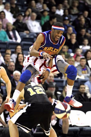 This is a contributed photo of Harlem Globetrotter Cheese Chisholm leap-frogging over another player. CONTRIBUTED PHOTO/