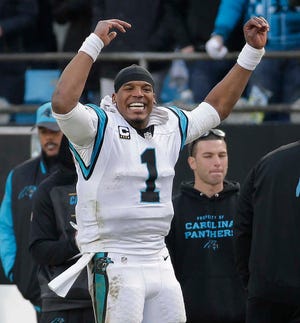 Carolina Panthers quarterback Cam Newton cheers on the sideline during the second half of a divisional round playoff game against the Seattle Seahawks on Sunday in Charlotte, N.C. The Panthers won 31-24. (AP Photo/Chuck Burton)