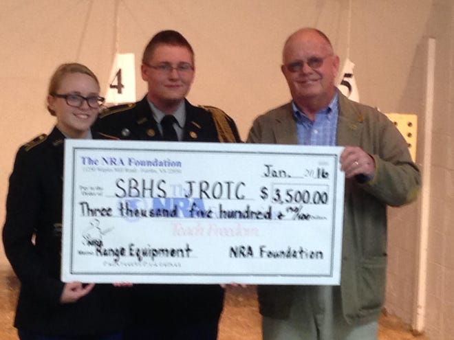 Cella Parmele and Micheal Collins of the South Brunswick JROTC accept a $3,500 donation from Ray Campbell, Chairman of the Wilmington Chapter of Friends of NRA. Contributed photo