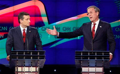 In this Dec. 15, 2015 file photo, former Florida Gov. Jeb Bush, right, makes a point as Sen. Ted Cruz, R-Texas listens on during the Republican presidential debate in Las Vegas. Ted Cruz once proudly wore a belt buckle reading "President of the United States" borrowed from George H.W. Bush. He campaigned and worked for, and helped write a book lavishing praise on, that former president's son, Dubya. And the endorsement of George P. Bush, the family's latest rising political star, lent credibility to Cruz's then little-known 2012 Senate campaign.