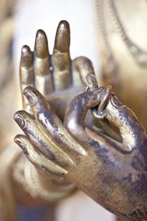 The hands of a statue in Oku Bahal, Patan, Nepal, exhibit the extraordinary heritage of metal craft in the Kathmandu valley. THOMAS L. KELLY/"HIMALAYAN STYLE"