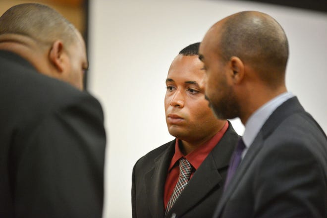 Eric Jefferson, center, talks with his father, left, and defense attorney James Smith during Jefferson's manslaughter trial. He was found guilty in the death of 3-year-old Jaliyah Vaughan.