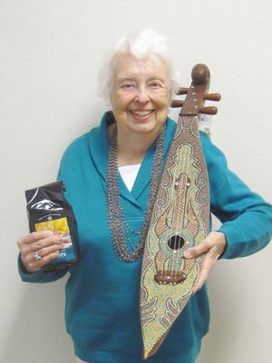 Martha Novinger, a member of the Joy Circle, lives in Destin. She is holding a bag of the fairly traded coffee and a gorgeous stringed instrument from Indonesia at last year's market.