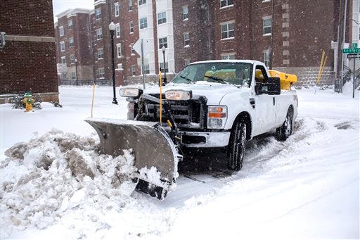 A WKU plow clears 13th Street on Friday, Jan. 22, 2016, in Bowling Green, Ky. A massive blizzard began dumping snow on the southern and eastern United States on Friday, with mass flight cancelations, five states declaring states of emergency and more than two feet (60 centimeters) predicted for Washington alone. Blizzard warnings or watches were in effect along the storm's path, from Arkansas through Tennessee and Kentucky to the mid-Atlantic states and as far north as New York. (Austin Anthony/Daily News via AP) MANDATORY CREDIT