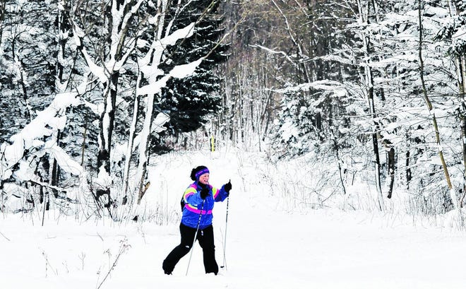 Lydia Rhodes, 44, of Greene Township, treks through the snow on cross-country skis at Wilderness Lodge in Venango Township on Jan. 11. ANDY COLWELL/