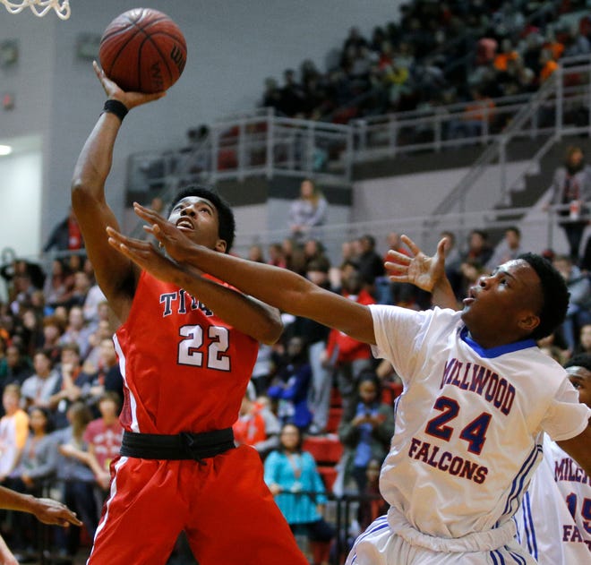 Carl Albert's Treyvon Hopkins shoots the ball beside Millwood's Deontre Price during a basketball game at Carl Albert High School in Midwest City, Okla., Thursday, Jan. 21, 2016. Photo by Bryan Terry, The Oklahoman