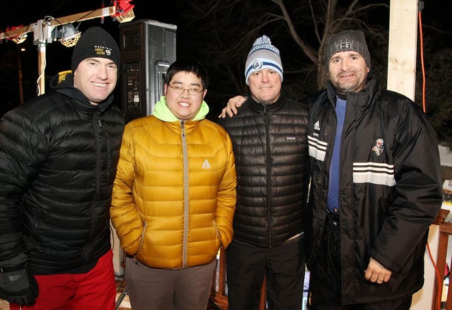 Gregory Wang, second from left, whose wish of meeting the Boston Bruins was granted last year, was at the Traynor Wish Winter Classic Backyard Hockey Tournament in Hingham on Friday, Jan. 22, 2016. He's with former Bruins players, from left, Bobby Allen of Hingham, Eric Healey of Hull and Rich Brennan of Hingham