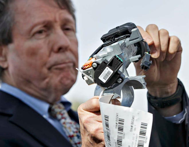 FILE - In this April 1, 2014, file photo, Clarence Ditlow, executive director of the Center for Auto Safety, displays a GM ignition switch similar to those linked to 13 deaths and dozens of crashes of General Motors small cars like the Chevy Cobalt, during a news conference on Capitol Hill in Washington. A civil trial starting January 2016 in New York City will test the legal boundaries of hundreds of claims remaining against General Motors over faulty ignition switches. (AP Photo/J. Scott Applewhite, File)