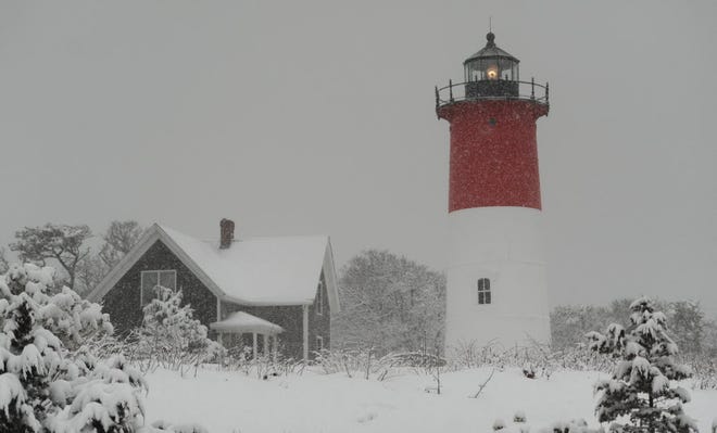 The beacon at Nauset Light cuts through the snow on March 5, 2015.