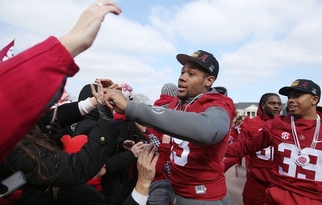 Alabama's Ar'Darius Stewart (13) and other players greet fans as they walk along the Walk of Champions in front of Bryant-Denny Stadium during the National Championship Celebration honoring the Crimson Tide's 16th national title in Tuscaloosa, Ala. on Saturday Jan. 23, 2016.  staff photo/Erin Nelson