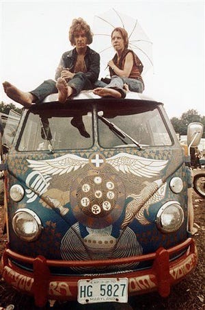 Concert-goers sit on the roof of a Volkswagen bus in 1969 at the Woodstock Music and Arts Fair in Bethel, N.Y. The fashion of the period is included in a new book, “The Looks of Love: 50 Moments in Fashion that Inspired Romance.”