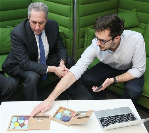 U.S. Trade Representative Michael Froman meets with a Polish start-up entrepreneur, Chris Waclawek with the company Estimote, in Warsaw, Poland, on Sunday Jan. 24, 2016. Froman was in Warsaw to meet with Polish leaders but also to learns about the developments of several young entrepreneurs and tells them of the benefits they will feel from a new transatlantic trade deal which the United States and the European Union are seeking to finalize.(AP Photo/Czarek Sokolowski)