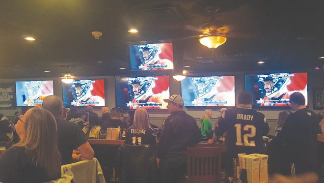 Fans at Barrett's Ale House on North Main Street watch the AFC Championship game between the New England Patriots and the Denver Broncos. New England lost, 20-18.