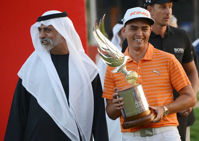 Rickie Fowler poses with the trophy next to Sheikh Nahyan bin Mubarak Al Nahyan, UAE Minister of Culture, Youth and Community Development, after winning the Abu Dhabi Golf Championship on Sunday in Abu Dhabi, United Arab Emirates. (AP Photo/Martin Dokoupil)