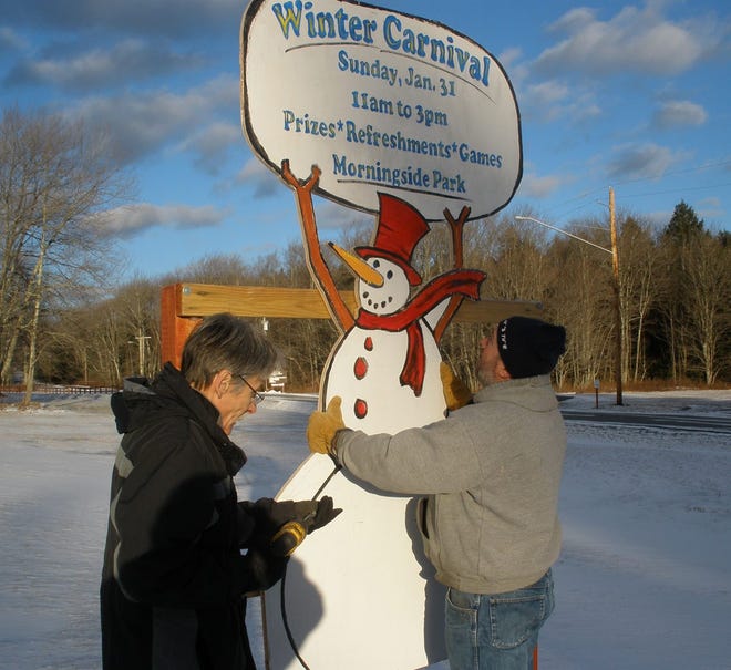 Town of Fallsburg Parks Department Gregg Bennett, administrator, left, and Mike Kehrley, a member of the staff, secure a sign announcing the upcoming Winter Carnival next Sunday. Photo provided