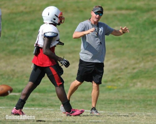 Coach Heath Webb speaks to a player after a play at Winder-Barrow practice on Aug. 5. (AJ Reynolds/Staff)