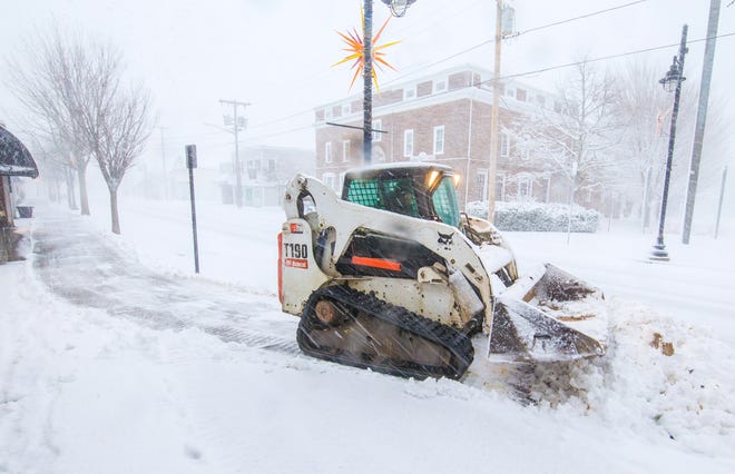 A plow pays a visit to Main Street in Hyannis during the nor'easter named Jonas on Saturday afternoon. PHOTO BY ALAN BELANICH