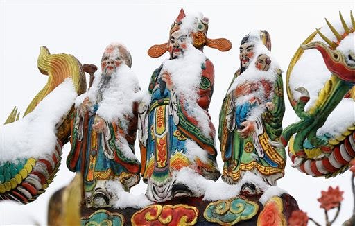 Snow sits on the Chinese god statues at the Pinglin temple in the high mountain area of New Taipei City, Taiwan, Monday, Jan. 25, 2016. An unusually cold weather front that caused sudden drops in temperatures has been blamed for killing as many as 57 people in Taiwan's greater Taipei area. (AP Photo/Wally Santana)