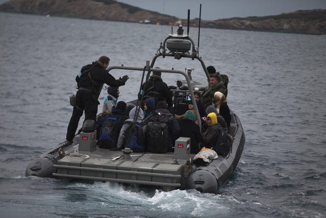 In this photo taken on Wednesday, Jan. 20, 2016, a Frontex speedboat with a Dutch crew transfers about 25 refugees and migrants from the deserted Greek island of Pasas to the nearby island of Oinousses, near Chios island. Chios, second in the number of arrivals after Lesbos, has three coast guard vessels as well as Frontex reinforcements. Hour after hour, by night and by day, Greek coast guard patrol and lifeboats, reinforced by vessels from the European Union's border agency Frontex, ply the waters of the eastern Aegean Sea along the frontier with Turkey, on the lookout for people being smuggled onto the shores of Greek islands - the frontline of Europe's massive refugee crisis. (AP Photo/Petros Giannakouris)