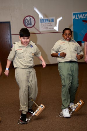 Michael Cole, 13, left, and Xavier Jones, 10, of Oklahoma City's Troop 1101, successfully launch their stomp rockets during Boy Scout Science Overnight at Science Museum Oklahoma. [Photo by M. Tim Blake, for The Oklahoman]