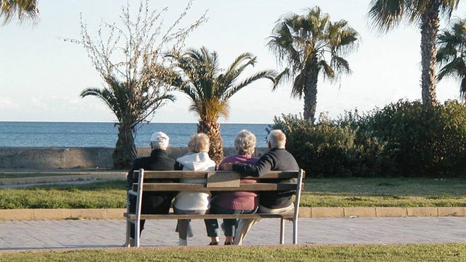 File photo of elderly couples on a bench.