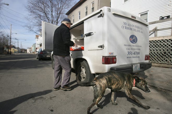 Meals on Wheels driver Sam Andrade delivers a hot meal in 2009. PROVIDENCE JOURNAL FILE PHOTO