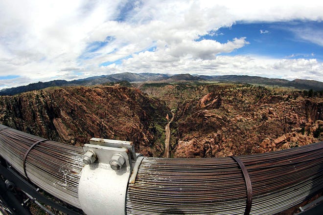 A view from the Royal Gorge Bridge through a fish-eye lens showcases the rugged scenery and the Arkansas River.
