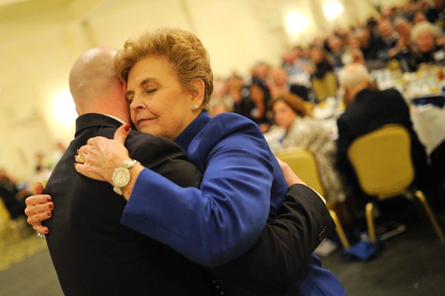 Rubielen Norris, the retiring President of the United Way of Northeast Georgia, hugs Matthew Purkey, the organization's incoming president, after an introductory speech largely honoring Norris during the annual award meeting and banquet for the United Way of Northeast Georgia on Tuesday, Jan. 26, 2016, in Athens, Ga. (AJ Reynolds/Staff, @ajreynoldsphoto)