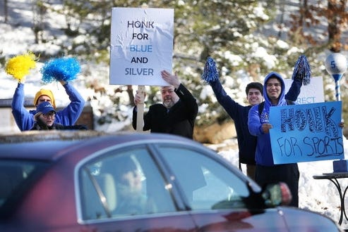 Joined by college President John L. Cox, center, Cape Cod Community College students rally to boost school spirit and drum up support to bring athletic programs back to the campus. 

Steve Haines photos/Cape Cod Times
