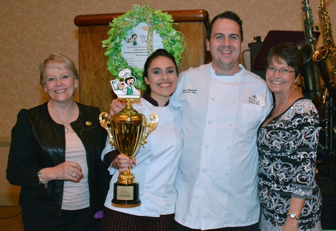 Pastry Chef Angie Malabet, of Bijoux, took home first place honors in Friday's Destin Desserts competition. Also pictured are Peggy McLane, left, Jack McGuckin and Gretchen Erickson.